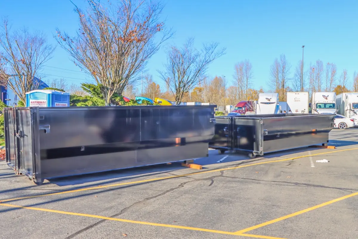 Professional dumpster rental service with roll-off container on residential driveway in North Druid Hills